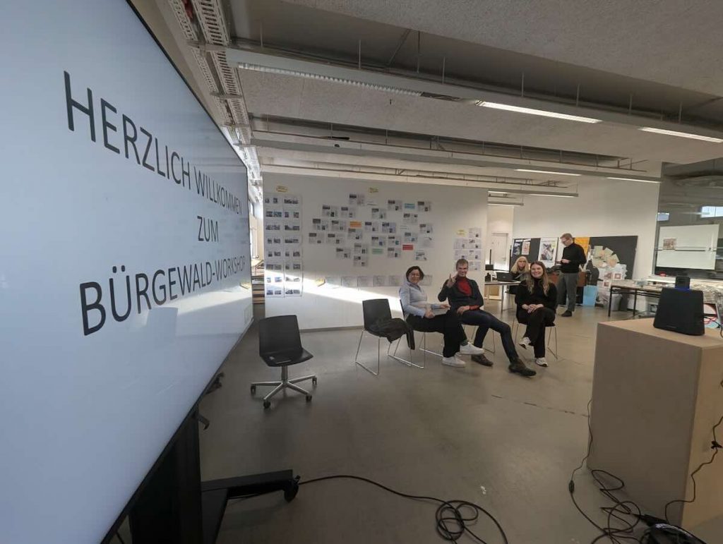 Teaching staff in the prepared room fpr the ReSET Colloquium welcoming everyone with a welcome slide.